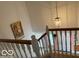 Staircase with a view of the entryway featuring a hanging light fixture and a painting at 8002 Windham Lake Way # 33, Indianapolis, IN 46214