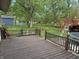 Spacious backyard featuring a wooden deck, playset and lush greenery at 802 Suwanee Ct, Indianapolis, IN 46217