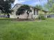 Exterior side view of home with lush green backyard and decorative shrubbery at 802 Suwanee Ct, Indianapolis, IN 46217