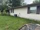 Exterior side view of home with lush green backyard and air conditioner at 802 Suwanee Ct, Indianapolis, IN 46217