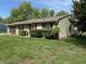 Exterior view of a well-maintained home with stone accents and green lawn at 802 Suwanee Ct, Indianapolis, IN 46217