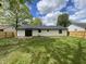 Home's backyard features a new fence and manicured grass at 817 Delray Dr, Indianapolis, IN 46241