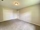 A carpeted bedroom with a closet and white painted door and trim at 817 Delray Dr, Indianapolis, IN 46241
