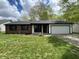 Charming single-story home featuring a brick facade, attached garage, and a well-manicured lawn at 817 Delray Dr, Indianapolis, IN 46241