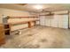Spacious garage with built-in shelving and a roll-up door at 817 Delray Dr, Indianapolis, IN 46241