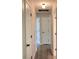 Hallway with laminate flooring, light walls, white doors and black hardware creates a clean, modern feel at 817 Delray Dr, Indianapolis, IN 46241