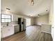 Open-concept kitchen with stainless steel appliances and white cabinets seamlessly connects to the living area at 817 Delray Dr, Indianapolis, IN 46241