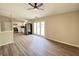 Bright room featuring laminate flooring and a ceiling fan that connects to the kitchen through an open doorway at 817 Delray Dr, Indianapolis, IN 46241