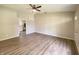 Large living room with laminate flooring and a ceiling fan that connects to an open kitchen at 817 Delray Dr, Indianapolis, IN 46241