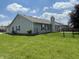 Spacious fenced backyard with a covered patio and a well-maintained lawn, ideal for outdoor activities at 8234 Crosser Dr, Indianapolis, IN 46237