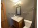 A view of the vanity with sink, toilet, and chrome hardware in a modern bathroom at 8234 Crosser Dr, Indianapolis, IN 46237