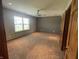 Bright bedroom featuring neutral walls, plush carpeting, and a ceiling fan at 8234 Crosser Dr, Indianapolis, IN 46237