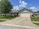 Charming single-story home with a well-maintained lawn, large tree, and a two-car attached garage at 8234 Crosser Dr, Indianapolis, IN 46237