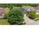 Aerial view of a brick home with mature landscaping and proximity to a scenic pond at 8316 Thorn Bend Dr, Indianapolis, IN 46278