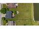 Aerial shot of a backyard with a fire pit and wooden deck, next to a pond at 8316 Thorn Bend Dr, Indianapolis, IN 46278