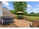 Back deck view showcasing outdoor dining area, hot tub, and peaceful backyard at 8316 Thorn Bend Dr, Indianapolis, IN 46278