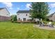 Well-maintained backyard featuring a wooden deck, fire pit area, and a lush lawn at 8316 Thorn Bend Dr, Indianapolis, IN 46278