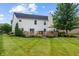Spacious backyard with deck, patio, lush lawn, and mature trees, ideal for outdoor enjoyment at 8316 Thorn Bend Dr, Indianapolis, IN 46278