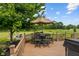 Outdoor deck with dining set, umbrella, and pond views; ideal for entertaining at 8316 Thorn Bend Dr, Indianapolis, IN 46278