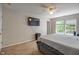 The cozy bedroom has carpet, a ceiling fan, and windows allowing lots of natural light into the space at 8316 Thorn Bend Dr, Indianapolis, IN 46278