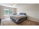 The bedroom includes a ceiling fan, carpet flooring, and bright natural light through the windows at 8316 Thorn Bend Dr, Indianapolis, IN 46278