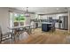 Bright dining area with views to the green outdoors, a stylish chandelier, and ample seating space at 8316 Thorn Bend Dr, Indianapolis, IN 46278