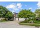 Traditional brick and siding home with a large front yard and a two-car garage, landscaped with mature trees at 8316 Thorn Bend Dr, Indianapolis, IN 46278