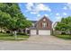 Charming brick home featuring a well-maintained lawn, mature trees, and an attached two-car garage at 8316 Thorn Bend Dr, Indianapolis, IN 46278