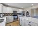 Spacious kitchen featuring white cabinetry, stainless steel appliances, and a center island with a stone countertop at 8316 Thorn Bend Dr, Indianapolis, IN 46278