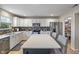 Bright kitchen featuring white cabinets, stainless steel appliances, and a functional center island with a stone counter at 8316 Thorn Bend Dr, Indianapolis, IN 46278