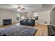 Cozy living room with hardwood floors, a fireplace, a comfortable sofa, and stairs to the upper level at 8316 Thorn Bend Dr, Indianapolis, IN 46278