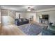 Inviting living room featuring a plush sofa, modern ceiling fan, and a cozy area rug on light hardwood floors at 8316 Thorn Bend Dr, Indianapolis, IN 46278