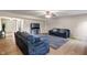 Bright living room showcasing comfortable seating, a modern ceiling fan, and light hardwood floors throughout the space at 8316 Thorn Bend Dr, Indianapolis, IN 46278