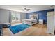 The primary bedroom features hardwood floors, and large windows filling the space with natural light at 8316 Thorn Bend Dr, Indianapolis, IN 46278