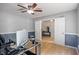Bright office area with a ceiling fan, hardwood floors, and an open doorway at 8316 Thorn Bend Dr, Indianapolis, IN 46278