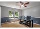 Well-lit office space with a ceiling fan, modern desk, hardwood floors, and large windows at 8316 Thorn Bend Dr, Indianapolis, IN 46278