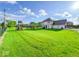 Expansive backyard features lush green lawn, and a play structure at 8798 Surrey Dr, Pendleton, IN 46064