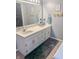 Bathroom with double sink vanity, large mirror, updated decor, and neutral gray walls at 8798 Surrey Dr, Pendleton, IN 46064
