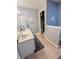 Neutral-toned bathroom with a double sink vanity, tiled flooring, and access to a walk-in closet at 8798 Surrey Dr, Pendleton, IN 46064