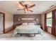 Bedroom with a decorative accent wall and lighted ceiling fan at 8798 Surrey Dr, Pendleton, IN 46064