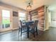 Dining area with a wooden accent wall, a modern light fixture, and a backyard view at 8798 Surrey Dr, Pendleton, IN 46064