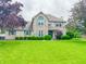 Charming two-story home with brick exterior, green shutters, and well-manicured lawn and landscaping at 8798 Surrey Dr, Pendleton, IN 46064