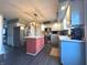 Well-lit kitchen with stainless steel appliances, white cabinets, and an island with seating at 8798 Surrey Dr, Pendleton, IN 46064