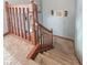 Carpeted staircase with a wooden banister featuring decorative balusters and carpeted stairs at 8798 Surrey Dr, Pendleton, IN 46064