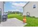 Large backyard with lush green grass, a patio area, and play equipment in the distance at 900 Sunchaser Rd, Lebanon, IN 46052