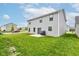 Backyard with patio, grill, and landscaped lawn, perfect for relaxing and enjoying the outdoors at 900 Sunchaser Rd, Lebanon, IN 46052