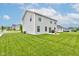 Spacious backyard featuring lush green grass, a patio with a grill, and a well-maintained lawn at 900 Sunchaser Rd, Lebanon, IN 46052