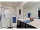 Well-lit bathroom features a glass shower door and double sink vanity at 900 Sunchaser Rd, Lebanon, IN 46052