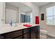 Bathroom featuring a double sink vanity, large mirror, and natural light from the window at 900 Sunchaser Rd, Lebanon, IN 46052
