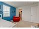 Bedroom with accent wall and a red swivel chair at 900 Sunchaser Rd, Lebanon, IN 46052